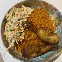 plate of chicken and jollof rice